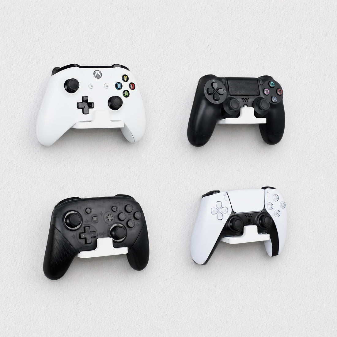 Wall-mounted gaming controller holders installed on a smooth painted wall