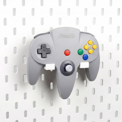 Porcelain White Nintendo 64 controller holder mounted on an IKEA SKÅDIS pegboard