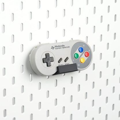 Pure Black SNES and Super Famicom controller holder mounted on an IKEA SKÅDIS pegboard