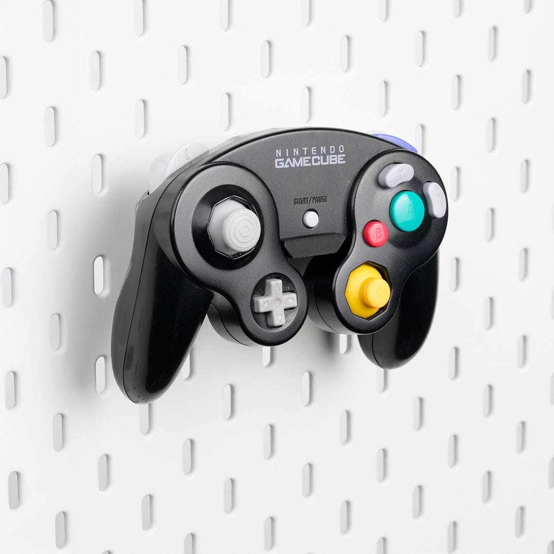 Pure Black GameCube controller holder mounted on an IKEA SKÅDIS pegboard