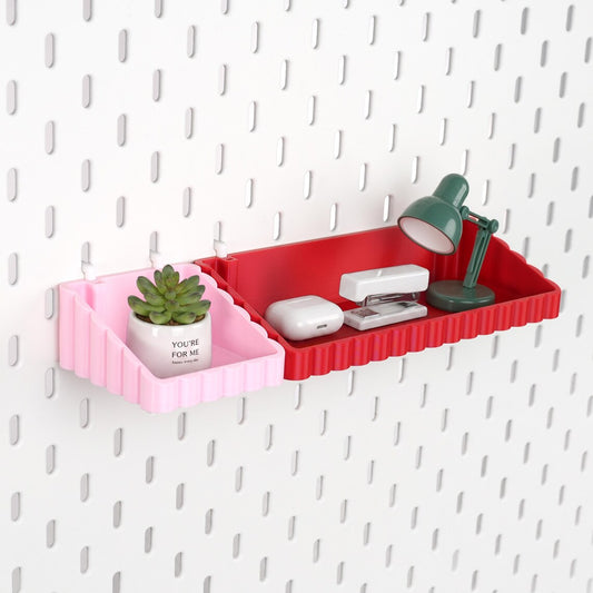 Pink and red wave pegboard storage shelves holding small desk accessories
